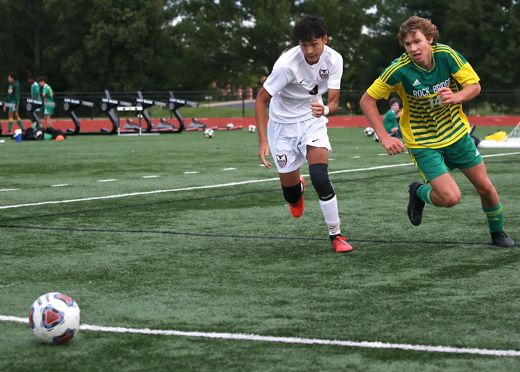 Rock Bridge senior Wesley Goyette, right, and Marshall senior Jerome Likerio fight for the ball during a match
